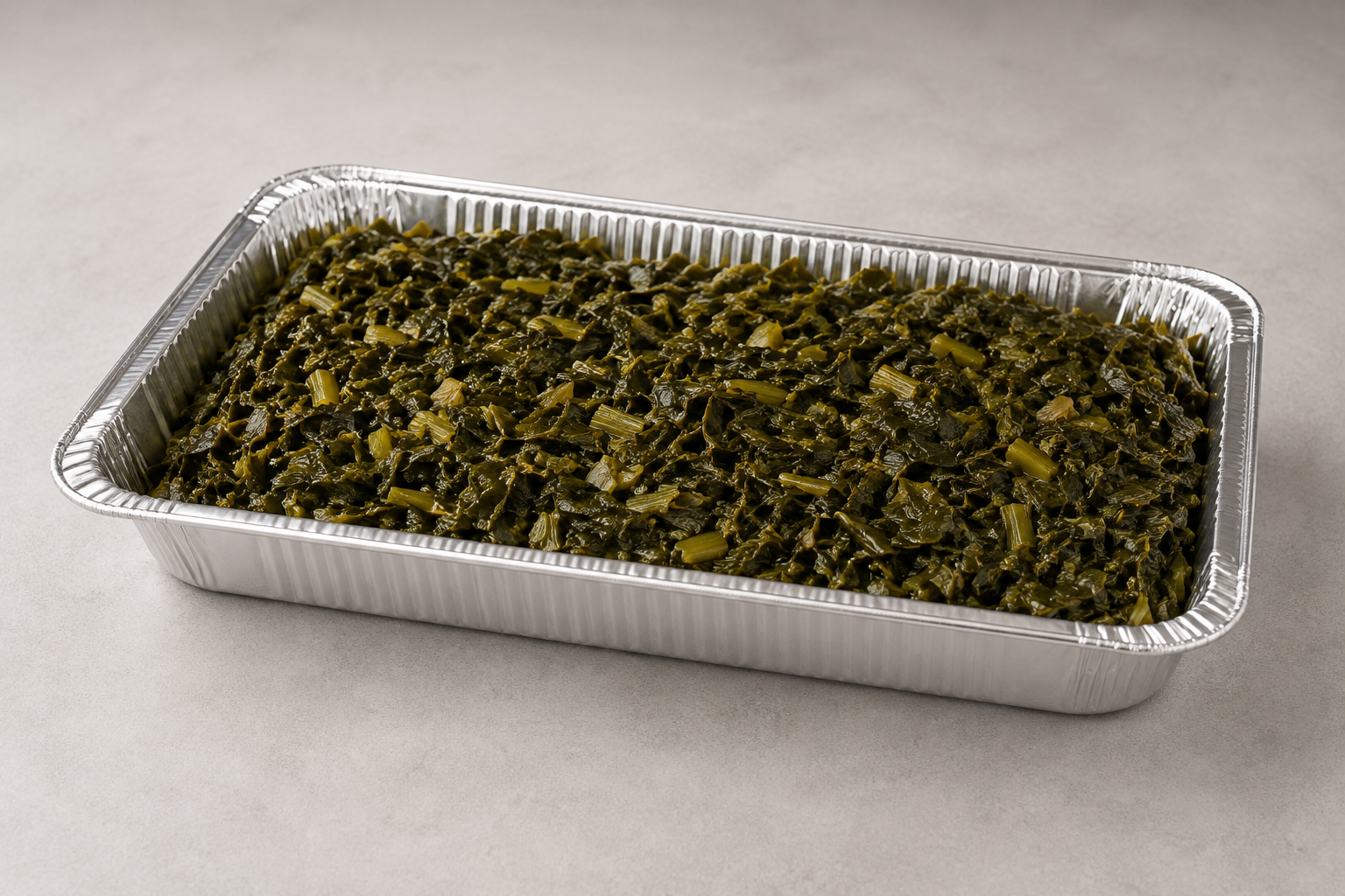 Full catering tray of slow-cooked collard greens